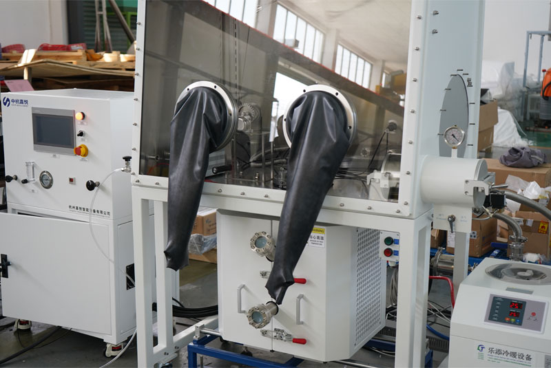 A CHJT laboratory glovebox with black rubber gloves, connected to an adjacent white control cabinet with a touchscreen interface.