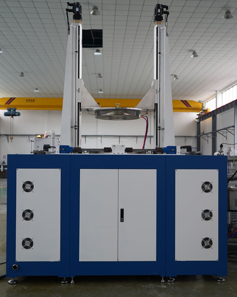 A large CHJT industrial machine with a blue and white base and two tall vertical arms lifting a large, circular metal component in a factory